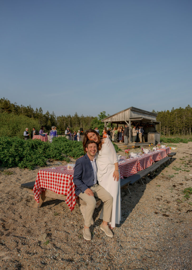 Maine harbor with lobster boats near Deer Isle, couple smiles for their wedding rehearsal dinner