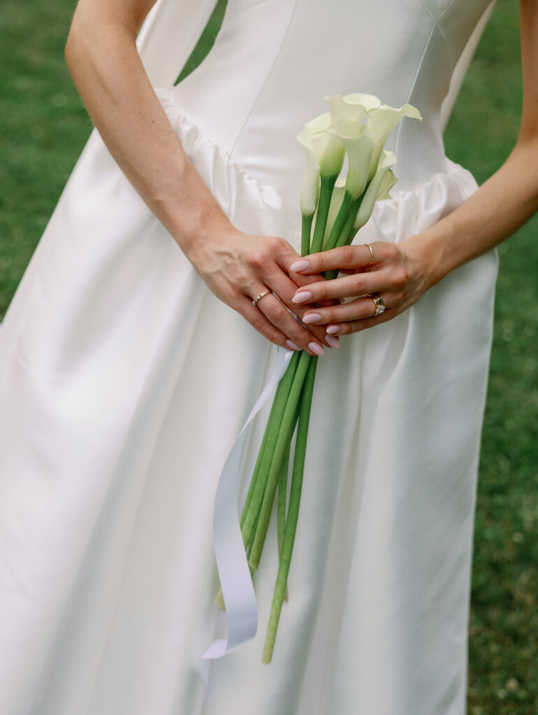 bride holds white flowers