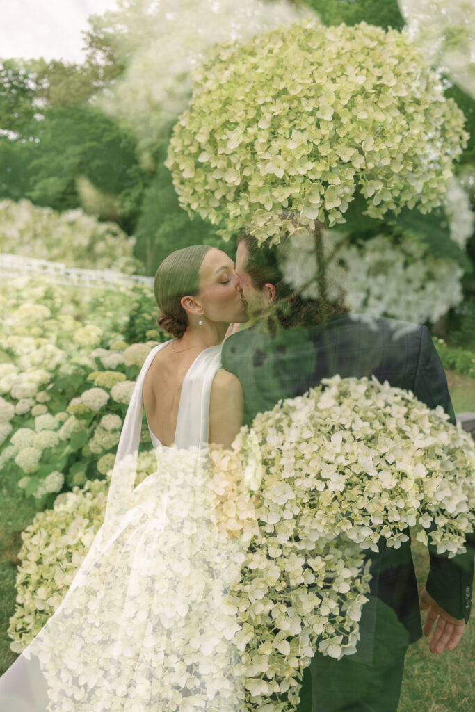 bride and groom kiss with flower overlay