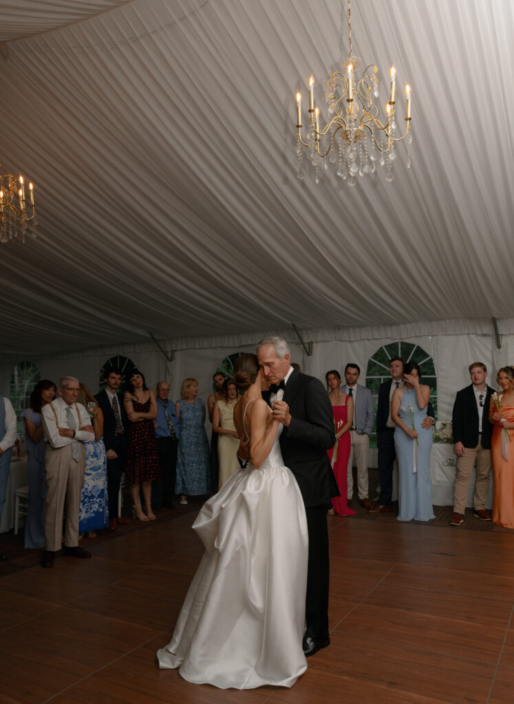 father and bride dance at wedding under white tent