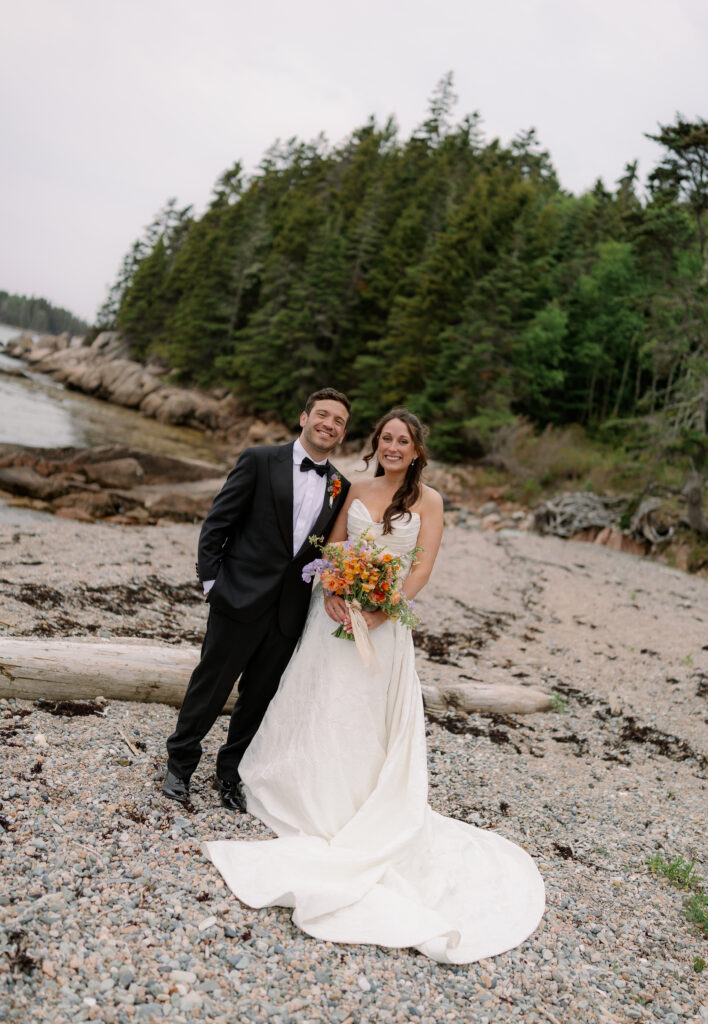Maine couple smiles on the beach at Maine wedding