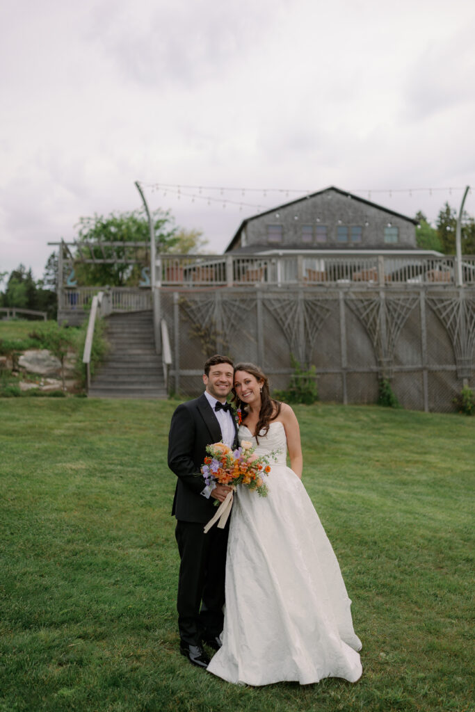 Bride and groom smile at Deer Aisle in Maine wedding